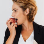 FEGLI Option A ; image: woman biting apple