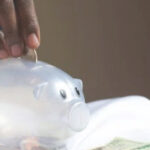 funding fers ; image: hand putting coin in a piggy bank