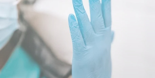 premium stabilization ; image: doctor putting on latex glove