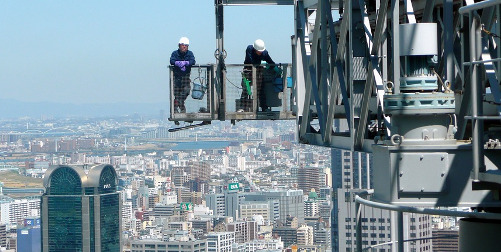 Hazard Pay for Federal Employees ; image: workers high above ground