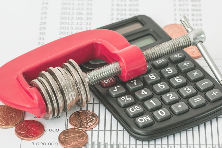 2023 Estimated Tax Payments ; image: coins in a vice grip next to calculator