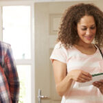social security income ; image: woman checking mail with smiling husband