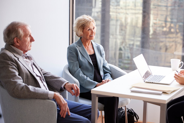 New RMD Rules ; image: older couple meeting with a professional