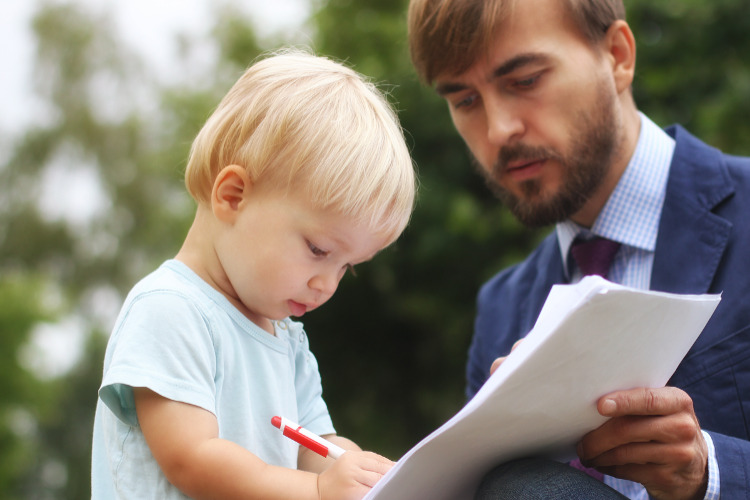 New RMD Rules, inherited IRAs ; image: man having toddler sign contract