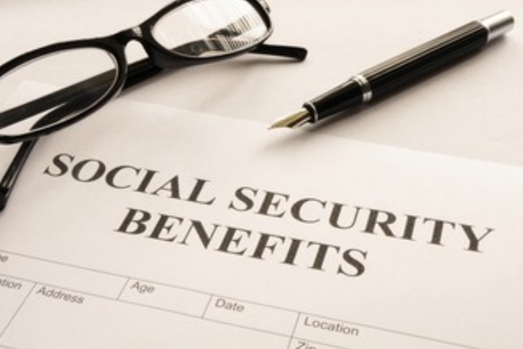social security statements ; image: glasses and pen on social security forms