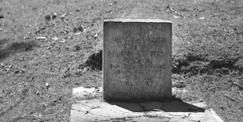 Survivor and Death Benefits image: black and white faded tombstone