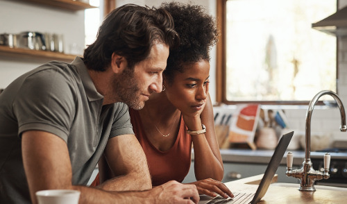 Tax Planning for Federal Employees ; image: couple looking at a computer together