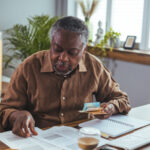 Social Security Myths ; image: older man calculating social security