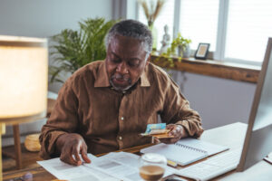 Social Security Myths ; image: older man calculating social security