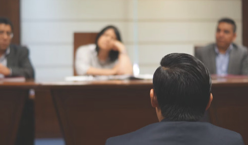 fegli death benefits ; image: man at legal hearing