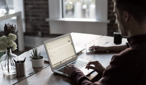 Quiz for Federal Employees, image: man working from home in the shadows