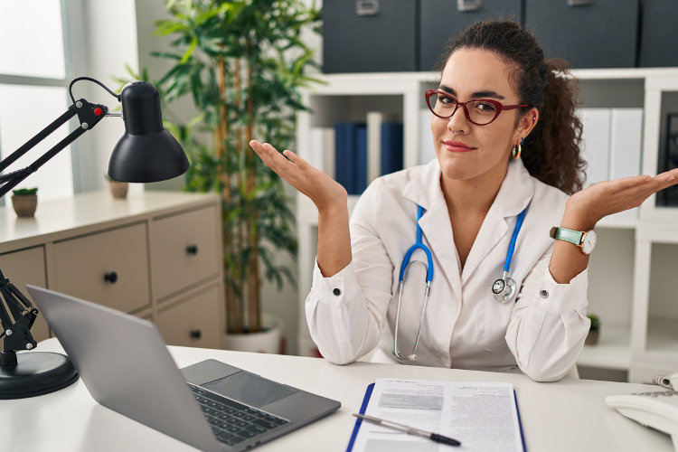 10 myths about federal employee health benefits ; image: doctor at desk shrugging