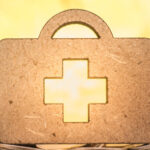 2024 HSA Contribution Limit for Federal Employees ; image: gold first aid kit on coins