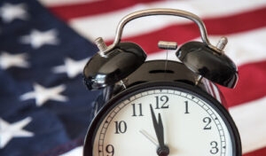 2024 Federal Pay Raise and Government Shutdown ; image: clock and american flag