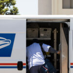 New Health Insurance Program for USPS ; image: mail carrier digging in truck