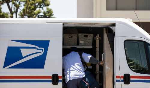 New Health Insurance Program for USPS ; image: mail carrier digging in truck