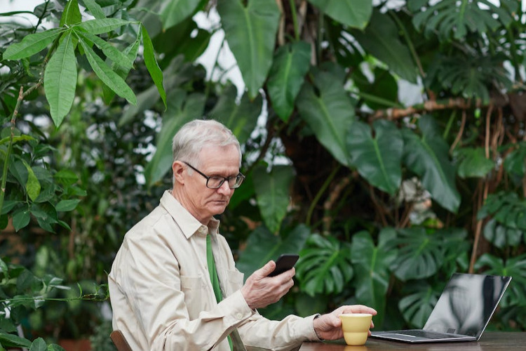 Lower TSP and Traditional IRA RMDs ; image: older man looking at his phone