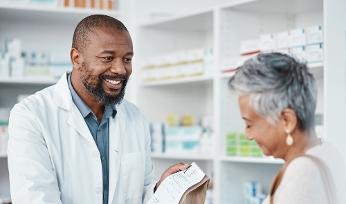 Medicare Part D ; image: a very smiley pharmacist