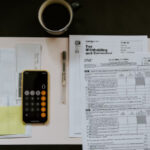 The Earnings Test ; image: cup of coffee, calculator, and tax docs