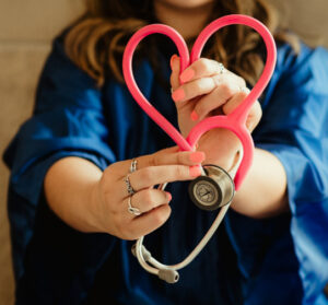 FEHB Open Season Webinar ; image: woman holding a heart stethoscope