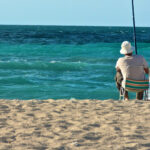 2024 COLA Podcast ; image: man fishing on the beach